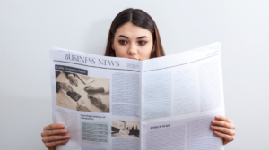 woman reading a newspaper